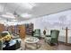 A comfortable lounge area features armchairs, tables, and bookshelves with natural light in a 55+ community at 970 Jolanda Cir, Venice, FL 34285