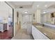 Bathroom featuring a vanity with granite counters, a soaking tub, and a mirrored wall at 101 Benjamin Franklin Dr # 71, Sarasota, FL 34236