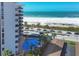 An elevated shot showcasing the beachfront location with pool, beach, and ocean views at 101 Benjamin Franklin Dr # 71, Sarasota, FL 34236
