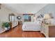 Bright bedroom with hardwood floors and balcony access at 101 Benjamin Franklin Dr # 71, Sarasota, FL 34236