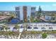 Aerial view of a high-rise condominium building with beach access and a community pool at 101 Benjamin Franklin Dr # 71, Sarasota, FL 34236