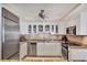 Updated kitchen has stainless steel appliances, white cabinets and a tile backsplash at 101 Benjamin Franklin Dr # 71, Sarasota, FL 34236