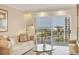 Relax in this living room with access to a balcony and amazing ocean views at 101 Benjamin Franklin Dr # 71, Sarasota, FL 34236