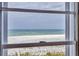 Stunning ocean view framed by a window, offering breathtaking beach scenery at 101 Benjamin Franklin Dr # 71, Sarasota, FL 34236
