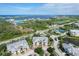 Breathtaking aerial view of the community showcasing water views, tennis courts and perfectly manicured grounds at 10600 Lemon Creek Loop # 102, Englewood, FL 34224