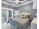 Bedroom with neutral colors, a ceiling fan, and a balcony at 10600 Lemon Creek Loop # 102, Englewood, FL 34224