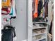 Well-organized walk-in closet with shelves and hanging racks for ample storage at 10600 Lemon Creek Loop # 102, Englewood, FL 34224