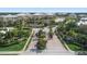 Beautiful community entrance with tropical landscaping, water feature, and an American flag at 10600 Lemon Creek Loop # 102, Englewood, FL 34224