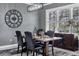 Elegant dining room featuring a modern light fixture, decorative wall clock, and stylish furniture at 10600 Lemon Creek Loop # 102, Englewood, FL 34224