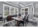 Inviting dining room with large windows and shutters, complemented by a modern light fixture and decor at 10600 Lemon Creek Loop # 102, Englewood, FL 34224