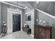 Welcoming entryway features a stylish black door, elegant light fixture, and a convenient bench at 10600 Lemon Creek Loop # 102, Englewood, FL 34224