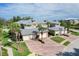 Community featuring brick driveways, attached garages, lush landscaping, and neutral-colored exteriors at 10600 Lemon Creek Loop # 102, Englewood, FL 34224