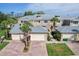 Townhome with brick driveways, attached garages, beautiful landscaping, and neutral-colored exterior at 10600 Lemon Creek Loop # 102, Englewood, FL 34224