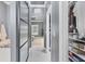 Hallway with a modern design featuring a sleek sliding door, bright lighting, and an organized closet at 10600 Lemon Creek Loop # 102, Englewood, FL 34224