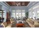 Bright living room with high ceilings, wood floors, comfortable seating, and views of the outdoors at 10600 Lemon Creek Loop # 102, Englewood, FL 34224