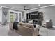 Bright living room with a cozy sofa, stylish decor, and an entertainment center for media enjoyment at 10600 Lemon Creek Loop # 102, Englewood, FL 34224