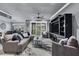 Spacious living room with comfortable seating, a modern entertainment center, and natural light at 10600 Lemon Creek Loop # 102, Englewood, FL 34224