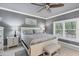 Serene main bedroom with neutral tones, a ceiling fan, and bright natural light at 10600 Lemon Creek Loop # 102, Englewood, FL 34224