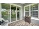 Covered patio with outdoor grill and brick floor at 10600 Lemon Creek Loop # 102, Englewood, FL 34224