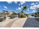 Community pool area with BBQ and plenty of seating for outdoor gatherings and enjoying the beautiful surroundings at 10600 Lemon Creek Loop # 102, Englewood, FL 34224
