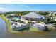Aerial view of a community pool and clubhouse surrounded by lush landscaping, providing a resort-style experience at 10600 Lemon Creek Loop # 102, Englewood, FL 34224