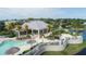A sun-drenched community pool and clubhouse, surrounded by tropical palms and landscaping with ample seating options at 10600 Lemon Creek Loop # 102, Englewood, FL 34224