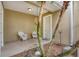 Inviting front porch featuring two white wicker chairs, hanging plants, and a lovely view at 10600 Lemon Creek Loop # 102, Englewood, FL 34224