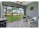 Enjoy this screened porch with comfortable seating and lovely backyard views at 10600 Lemon Creek Loop # 102, Englewood, FL 34224