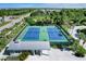 Overhead image of a neighborhood's tennis courts with a covered area and plenty of space for parking at 10600 Lemon Creek Loop # 102, Englewood, FL 34224