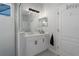 Well-lit bathroom with white cabinets, a modern vanity, and a glass-enclosed shower at 10919 Blue Magnolia Ln, Parrish, FL 34219
