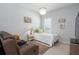 Cozy bedroom with a single bed, recliner, decorative lighting, and charming accents at 10919 Blue Magnolia Ln, Parrish, FL 34219