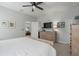 Bedroom boasts neutral colors, ceiling fan, and a dresser with decor at 10919 Blue Magnolia Ln, Parrish, FL 34219