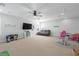 Large bonus room with a TV, comfortable seating, and a variety of toys and play areas at 10919 Blue Magnolia Ln, Parrish, FL 34219