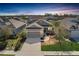 Charming single-Gathering home featuring a manicured lawn, two-car garage, and inviting front porch at 10919 Blue Magnolia Ln, Parrish, FL 34219