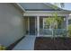 Inviting front porch with a gray door, decorative wreath, and white railing that provides a welcoming curb appeal at 10919 Blue Magnolia Ln, Parrish, FL 34219