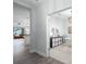 Open hallway leading to a bright living room and an adjacent office, showcasing the home's open floor plan at 10919 Blue Magnolia Ln, Parrish, FL 34219