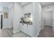 Inviting hallway with stylish decor and modern gray flooring at 10919 Blue Magnolia Ln, Parrish, FL 34219