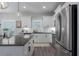 Bright kitchen with stainless steel appliances, white cabinets, and granite countertops at 10919 Blue Magnolia Ln, Parrish, FL 34219