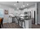 Modern kitchen featuring white cabinets, granite countertops, stainless steel appliances, and a breakfast bar with seating at 10919 Blue Magnolia Ln, Parrish, FL 34219