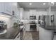 Beautiful kitchen featuring stainless steel appliances, white cabinetry, and granite counters at 10919 Blue Magnolia Ln, Parrish, FL 34219