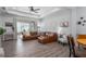 Inviting living area with wood floors, a cozy sectional, and modern decor at 10919 Blue Magnolia Ln, Parrish, FL 34219