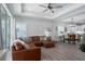 Inviting living space with a large sectional, sliding glass doors, and wood-look floors at 10919 Blue Magnolia Ln, Parrish, FL 34219