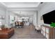 Open-concept living room showcasing kitchen and dining areas with modern finishes at 10919 Blue Magnolia Ln, Parrish, FL 34219