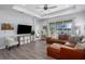 Comfortable living room with sliding doors leading to the outdoor lanai at 10919 Blue Magnolia Ln, Parrish, FL 34219