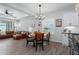 Open-concept living and dining area with modern lighting and wood-look floors at 10919 Blue Magnolia Ln, Parrish, FL 34219