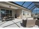 A covered patio features ample seating and dining, creating an ideal outdoor living space at 10919 Blue Magnolia Ln, Parrish, FL 34219