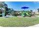 Community playground with a slide, benches, and shade offers a fun and safe recreational space for children at 10919 Blue Magnolia Ln, Parrish, FL 34219