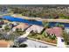 An aerial view shows the houses and landscaping, backing onto a scenic pond in the community at 11031 Hyacinth Pl, Lakewood Ranch, FL 34202