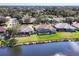 Aerial view of a home with a screened-in patio, backing onto a tranquil pond at 11031 Hyacinth Pl, Lakewood Ranch, FL 34202