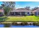 A well-maintained backyard with a pond view and screened-in patio creates an inviting outdoor space at 11031 Hyacinth Pl, Lakewood Ranch, FL 34202